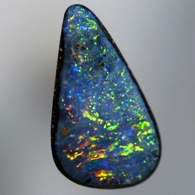 SOLID BOULDER OPAL Bright sparkles of red and gold over blue